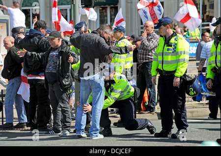 Police search members of the English Defence League before an EDL march through Brighton Stock Photo