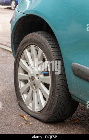 Puncture. Car with a flat tyre, England, UK Stock Photo