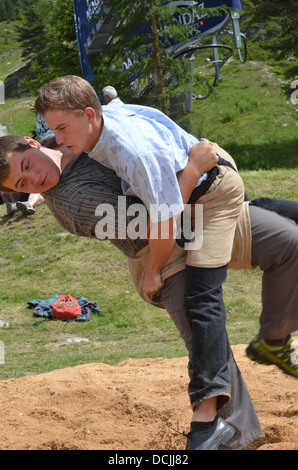 A throw at the amateur mens Swiss wrestling competition at the International Alpine Horn Festival: Stock Photo
