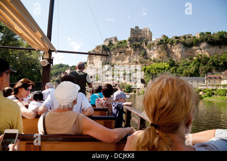 Tourists on a boat tour on the Dordogne River looking at the Chateau de Beynac, Beynac-et-Cazenac, France Europe Stock Photo