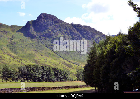 Looking across Great Langdale from Dungeon Ghyll Hotel towards Side Pike with pastoral land in the valley bottom, Lake District. Stock Photo