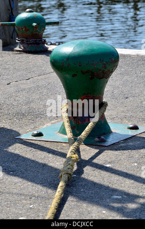 Mooring bollard on the quayside at Bowness with mooring rope from a steamer attached. Stock Photo