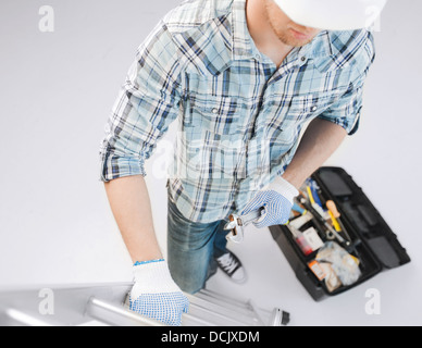 man with ladder, toolkit and spanner Stock Photo