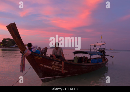 Local men relaxing on Longtail Boat - Ko Phi Phi Don - Krabi Province - Thailand Stock Photo