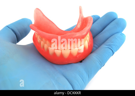 dentures in hand Stock Photo