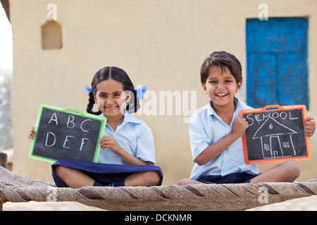 Portrait of happy children holding a slate Stock Photo - Alamy
