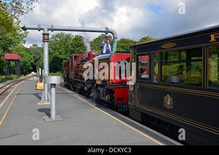 Welsh Highland Railway steam train taking water at Beddgelert Station. This is a Beyer-Garratt loco from South Africa. Stock Photo