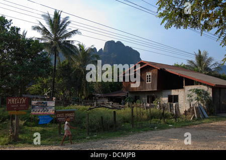 Horizontal view of traditional half built wooden home along a rough track close to Vang Vieng. Stock Photo