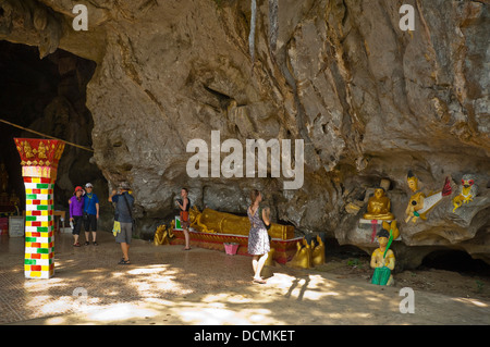 Horizontal view of tourists inside Tham Sang or Tham Xang, Elephant Cave near Vang Vieng Stock Photo