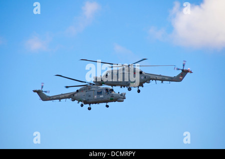Horizontal close up of two Westland Lynx helicopters flying towards each other during an stunt at an air show. Stock Photo