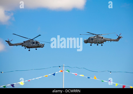 Horizontal close up of two Westland Lynx helicopters flying towards each other during an stunt at an air show. Stock Photo