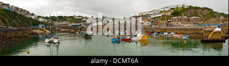Horizontal panoramic view across the harbour at Mevagissey on a dark cloudy day.