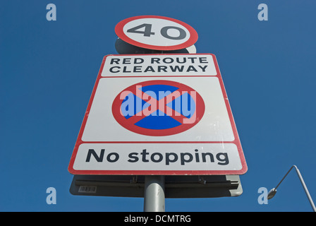 british red route clearway road sign with no stopping image and 40mph speed limit sign Stock Photo