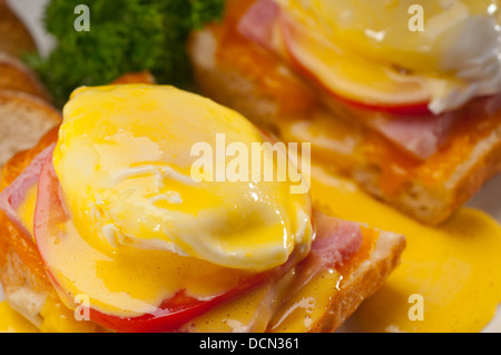 eggs benedict on bread with tomato and ham Stock Photo