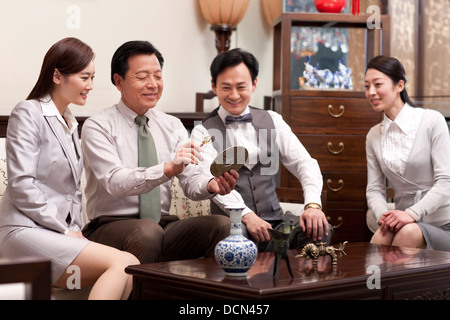 Business people admiring antiques Stock Photo