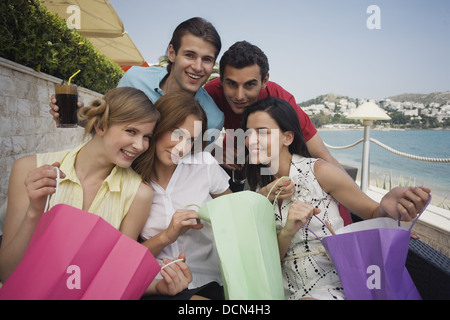 Group of friends with shopping bags posing Stock Photo