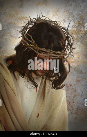 Portrait of Jesus with crown of thorns over old wall background Stock Photo