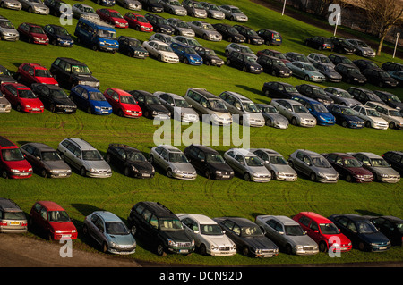 Old cars parked in rows in field