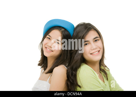 Two sisters sitting together, isolated on white Stock Photo