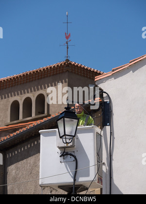 New street lights being fitted in the hilltop village of Bellegarde-du-Razes Aude Languedoc France Stock Photo