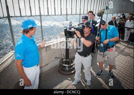 Manhattan, New York, USA. 20th Aug, 2013. RICKIE FOWLER, PGA Tour professional, ranked no. 42 in current FedExCup standings lights the Empire State Building in ''Barclays blue and white'' to commemorate the kickoff of the FedExCup Playoffs, which begin this week at The Barclays at Liberty National in Jersey City, N.J. Credit:  Bryan Smith/ZUMAPRESS.com/Alamy Live News Stock Photo