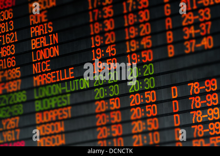 Departures and arrivals electronic orange led schedule in airport Stock Photo