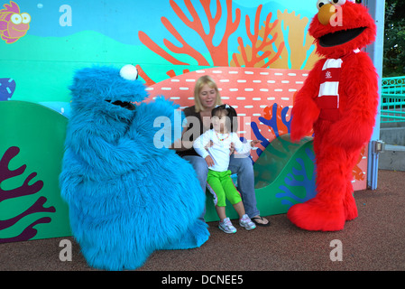 Cookie Monster and Elmo greet young girl at Sea World Stock Photo