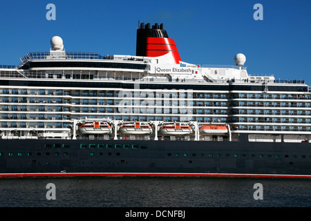 The newest MS Queen Elizabeth cruise ship near the port entrance after one day in Copenhagen. Denmark. Heading for Rostock, Germany. The QE 3 III Stock Photo