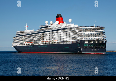 The newest MS Queen Elizabeth cruise ship near the port entrance in Copenhagen, Denmark after one sunny summer day. Heading for  Rostock. The QE 3 III Stock Photo