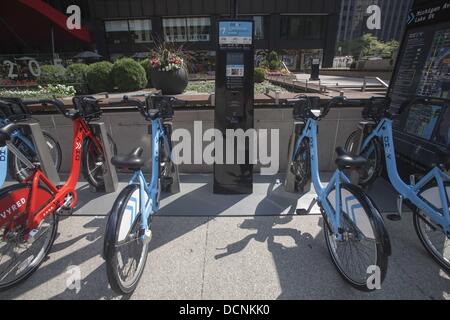 Chicago, Illinois, USA. 19th Aug, 2013. Bikes are seen at a Divvy Station on Monday, August. 19, 2013 in Chicago, Illinois. Divvy is a bicycle sharing system that launched in Chicago on June 28, 2013 with 750 bikes at 75 stations spanning from the Loop north to Fullerton Ave, west to Damen Ave, and south to 23rd St. The system is planned to grow to 3000 bikes at 300 stations by August 2013 and 4,000 bicycles at 400 stations by Spring 2014. © Ringo Chiu/ZUMAPRESS.com/Alamy Live News Stock Photo
