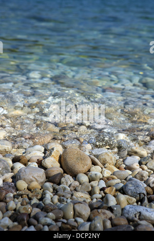 Pebbles at the water's edge on a Greek beach Stock Photo
