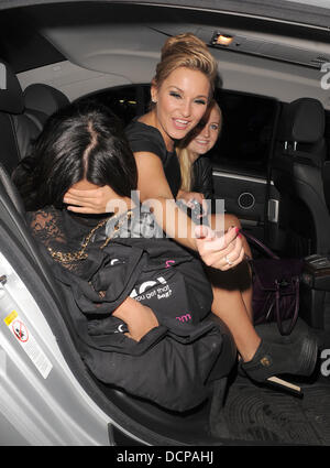 The Only Way is Essex stars Peri Sinclair and Samantha Faiers leaving Aura nightclub. A snapper made both Sam and Peri laugh hysterically as they got into their cab home, with Peri pointing out which photographer had made the joke. London, England - 03.11 Stock Photo