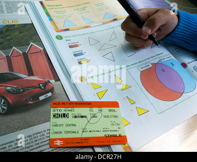 A Great Western train ticket and boy doing maths homework in train carriage on a trip to London  KATHY DEWITT Stock Photo