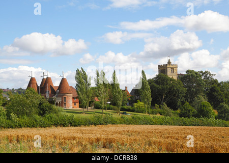 Horsmonden four kiln converted Oast House and St Margaret's Church Kent England UK Stock Photo