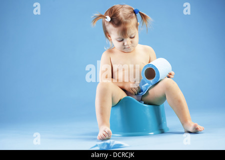 Cute toddler on potty chait Stock Photo