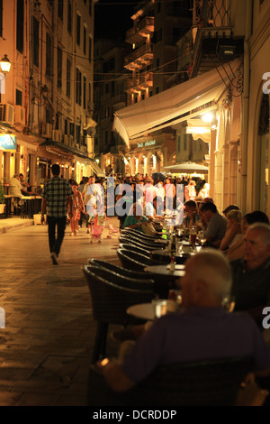 Busy street restaurants and cafes in the old part of Corfu Town Stock Photo