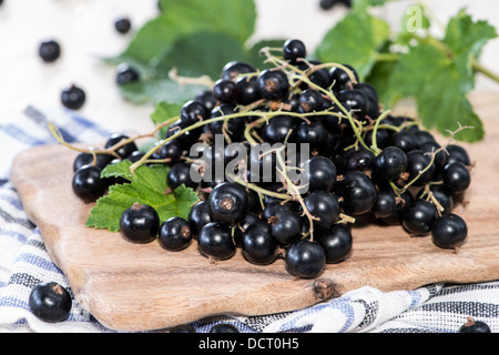 Heap of Black Currants on wooden background Stock Photo