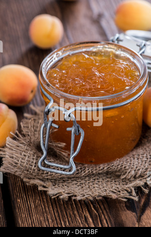Portion of Apricot Jam on rustic wooden background Stock Photo