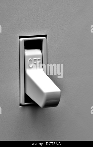 Light switch on wall inside a home in off position Stock Photo