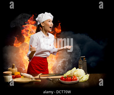 Asian woman furious cook, collage Stock Photo
