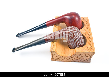 Two tobacco pipes on wooden holder isolated on white Stock Photo