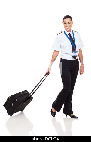 beautiful young woman in airline pilot uniform walking with briefcase on white background Stock Photo