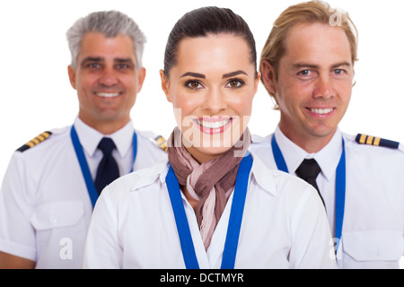 beautiful flight attendant standing in front of two pilots Stock Photo