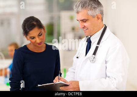 senior doctor checking young patient's test result Stock Photo