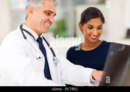 happy senior doctor examining patient's x-ray Stock Photo