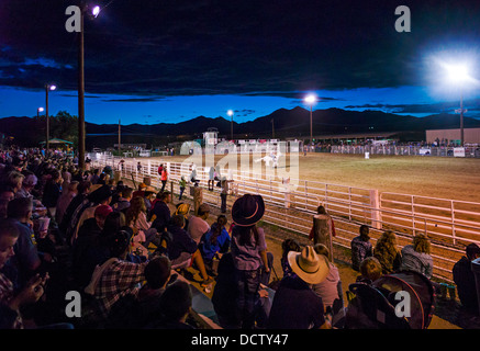 Nighttime view of spectators in bleachers watching the Chaffee County Fair & Rodeo Stock Photo