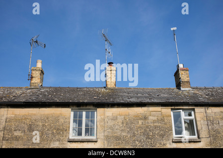 Row of cottages with roof TV aerials. Winchcombe, Gloucestershire, England Stock Photo