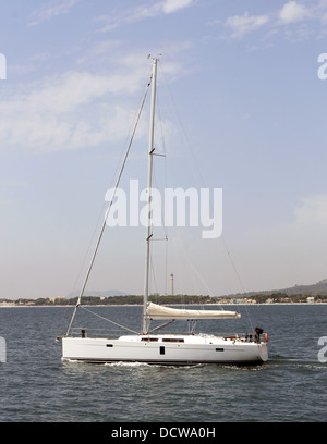 Side view of white yacht sailing on ocean. Stock Photo