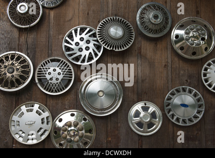 Vehicle hubcaps hanging on a wall. Stock Photo