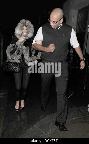 Chloe Sims and a mystery man leaving Loop Bar.  London, England - 15.12.11 Stock Photo